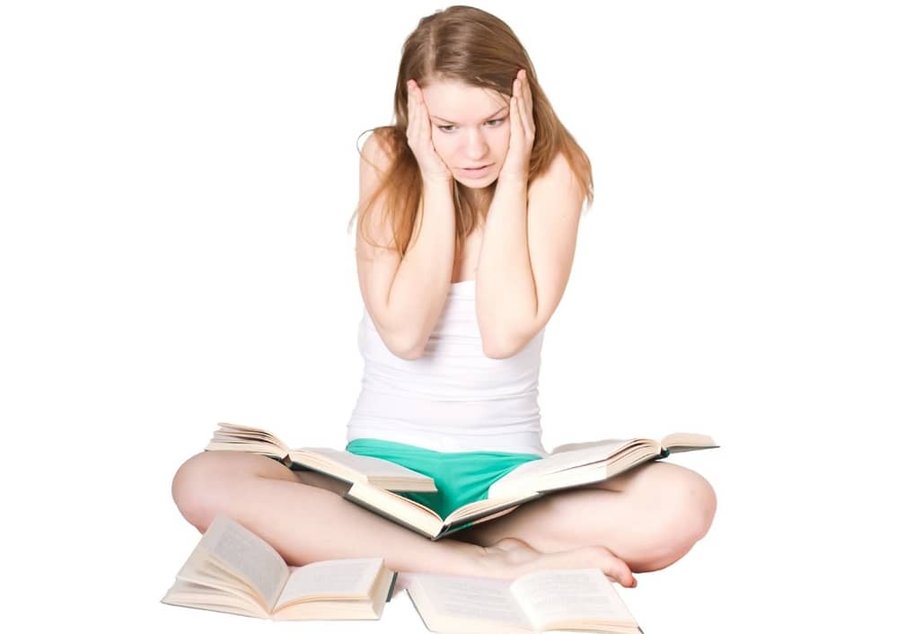 Overwhelmed student studying her books