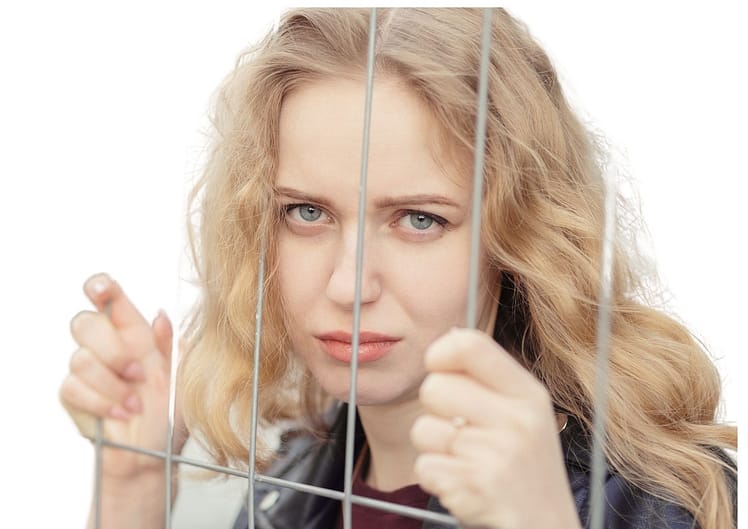 lady standing behind bars