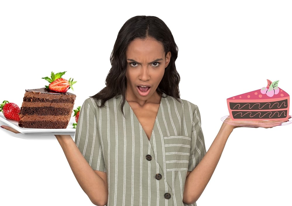 A lady holding one real cake and a picture of a cake looking confused